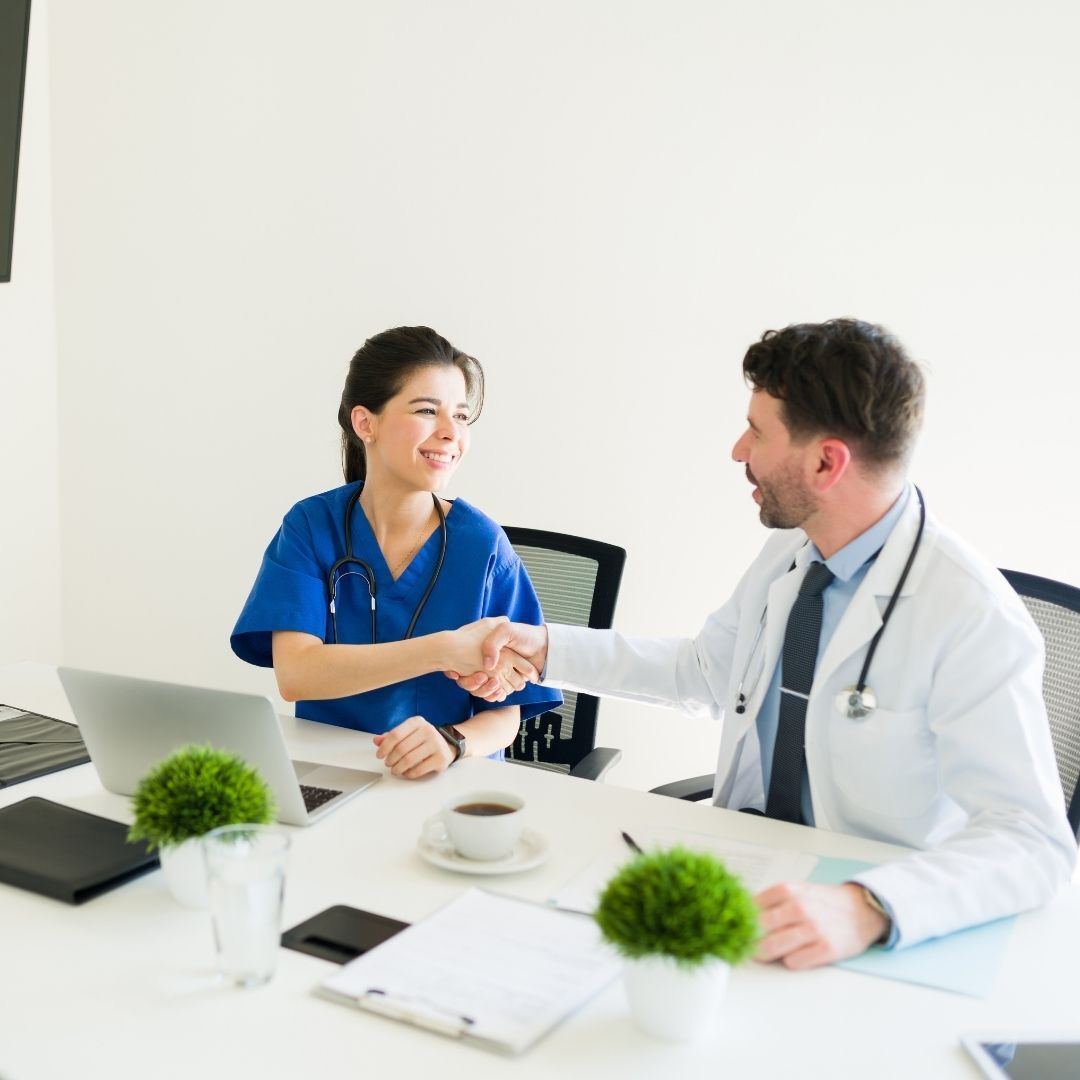 nurse and doctor shaking hands