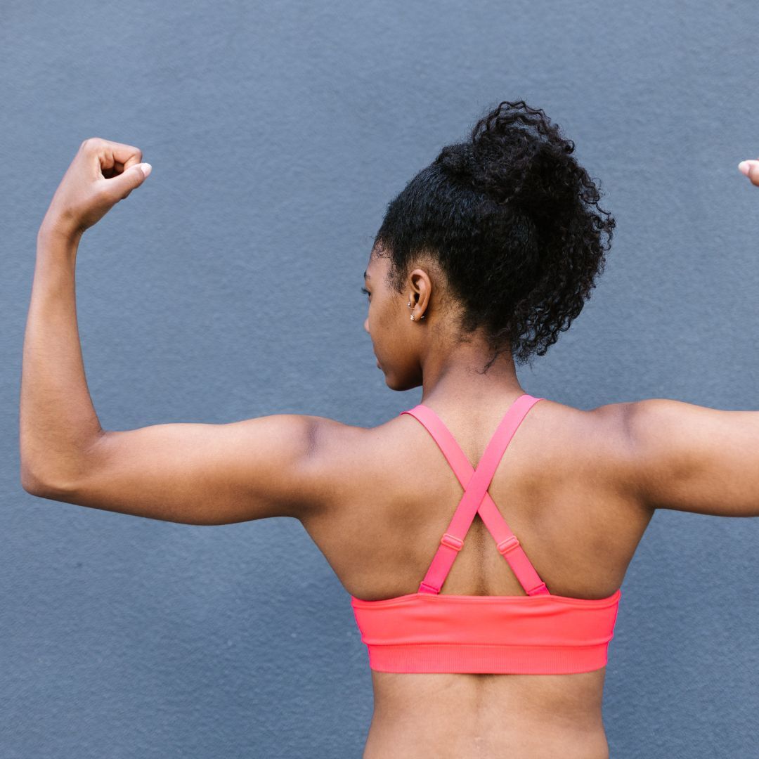 a woman flexing her muscles