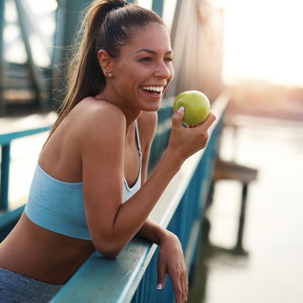 Women eating an apple during a run